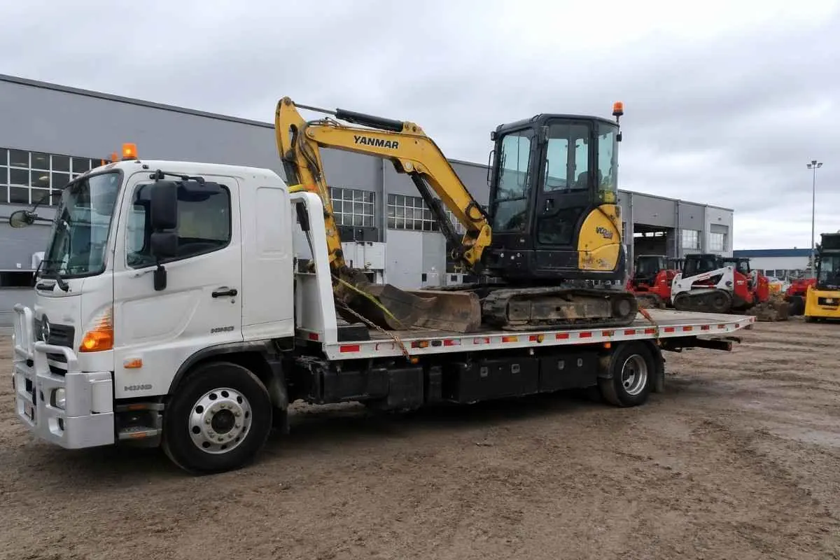 Excavator on tow truck